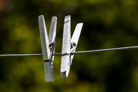 old wooden clothespins on wire lineの写真素材