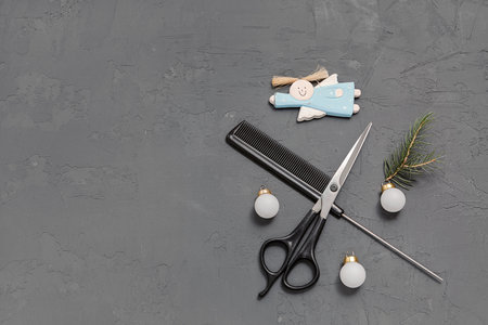 Christmas composition. Hairdressing tools on a gray background. Template for a postcard or information about a hair salon. Flat lay, copy space.の写真素材