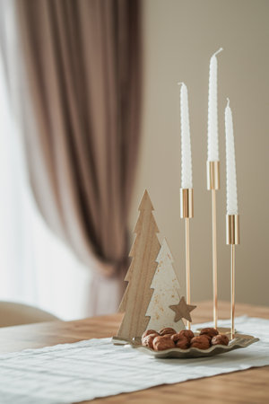 Gold candlesticks with candles, walnuts on theの写真素材