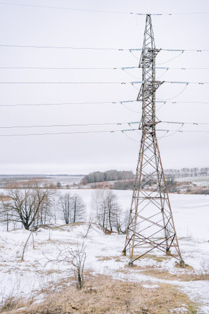 High-voltage tower in thefield in winter verticalの写真素材
