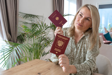 A girl holding two passports, Russian and Europeanの写真素材