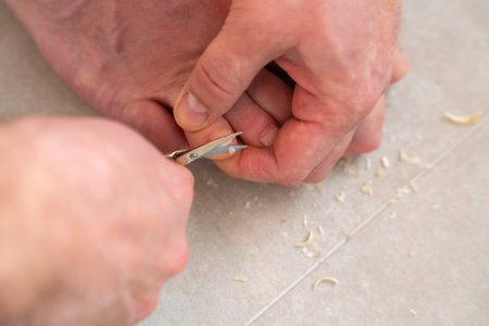 Man Trimming Toenails At Home Close-Upの写真素材