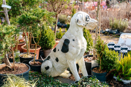 Dalmatian Dog Statue Amidst Lush Greenery inの写真素材