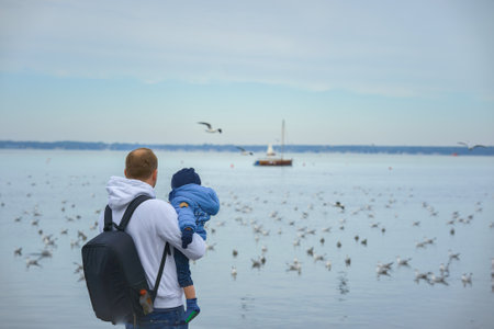A father holds his one-year-old son in his armsの写真素材