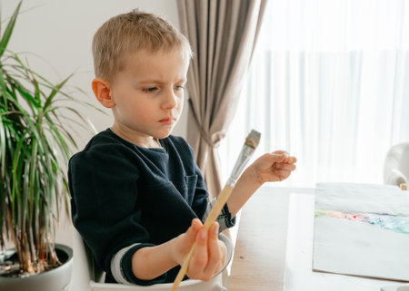 a boy of European appearance 4-5 years old sitsの写真素材