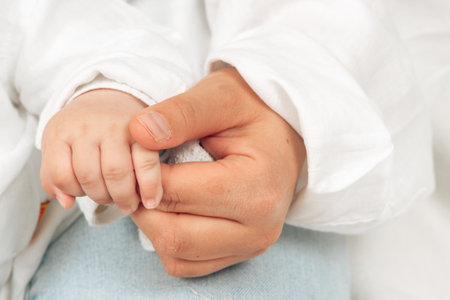 Parent and Baby Hand Holding Captured Close-Upの写真素材