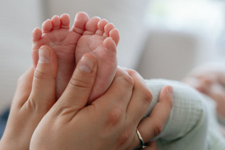 Gentle Touch: Parent Holding Newborn Feet