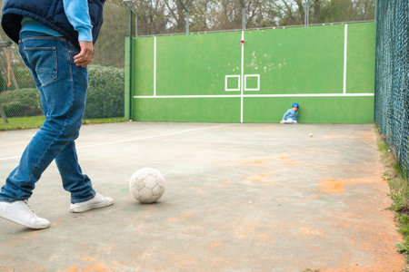 A man and a child are playing on a sports courtの写真素材