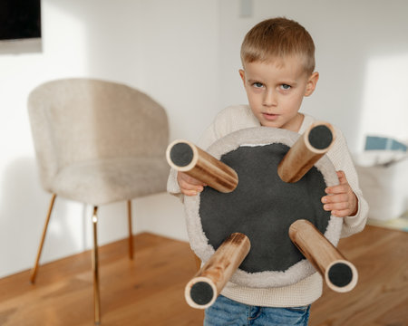 A smiling boy of 4 years old in the living roomの写真素材
