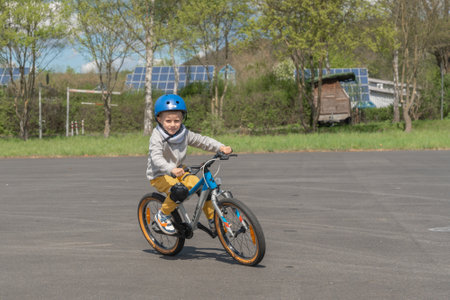 Child Enjoying a Ride on a Bicycle in a Parkの写真素材