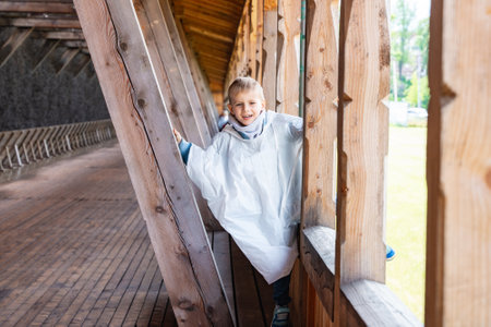 Happy Child Playing in Wooden Structure Outdoorsの写真素材