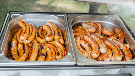 Hot Barbecue Bratwurst Served in Catering Dishの写真素材