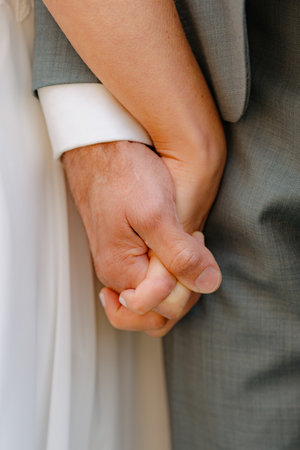 Close-Up of Couple Holding Hands on Wedding Dayの写真素材