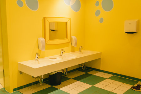 Bright Yellow Bathroom Interior with Double Sinksの写真素材