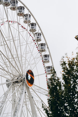 Ferris wheel shot through the autumn trees againstの写真素材