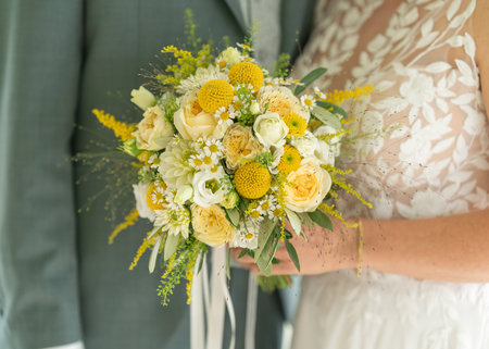 Bride Holding Yellow Floral Wedding Bouquetの写真素材