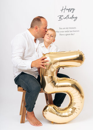 Father and Son Celebrate 5th Birthday with Loveの写真素材