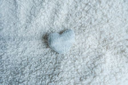 White heart lying on fluffy towel fabricの写真素材