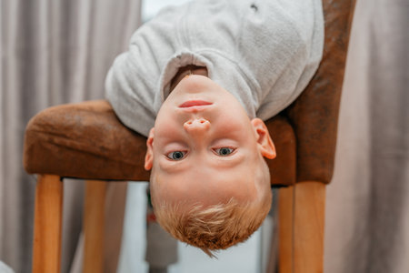 Playful Boy Hanging Upside Downの写真素材