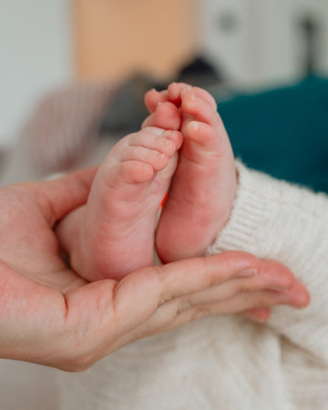 Baby Feet in Mothers Handsの写真素材