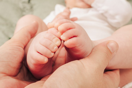 Parent Holding Baby Feetの写真素材