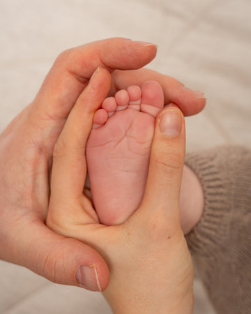 Parents Holding Baby Footの写真素材