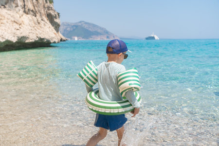Child on Clear Water Beach by Rocky Sardinianの写真素材