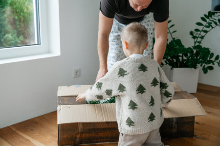 Child Opening Christmas Decoration Boxの写真素材