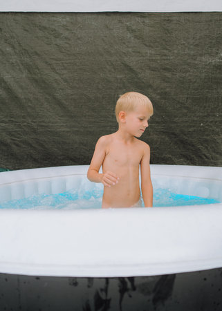 Child Enjoying Time in an Inflatable Poolの写真素材