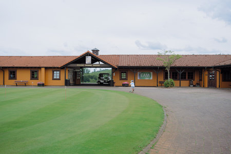 Golf Clubhouse with Child Playing Nearby on aの写真素材