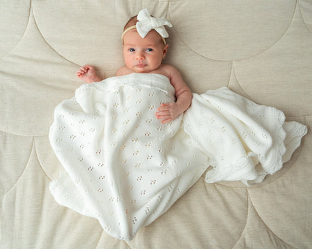 Top view of baby girl resting calmly at home. Cozy