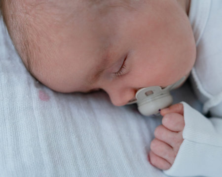 Peaceful infant nap with pacifier. Parenting and