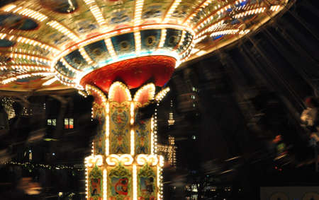 Spinning chain carousel at night/Spinning chain carousel with bright lights and vibrant colorsのeditorial素材