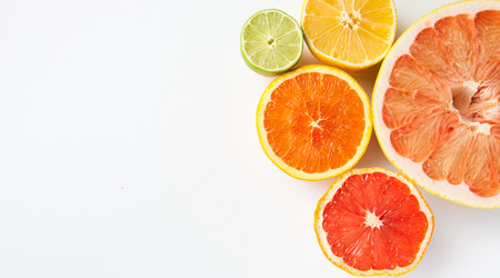 Close up of different citrus fruits - Myers lemon, lime, mandarin, grapefruit and pomelo.