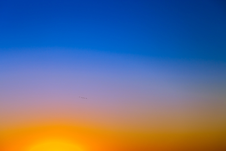 Background with gradient susnet sky in tones of yellow, orange and blue