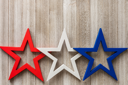 Wooden red, white and blue stars on a rustic background with copy space/4th of July background conceptの写真素材
