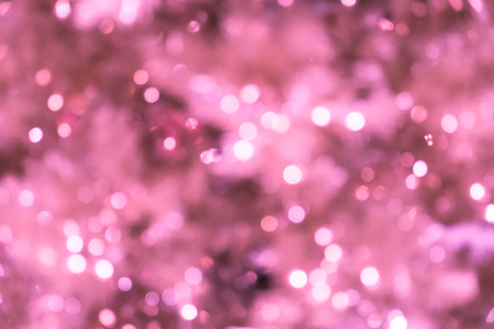 Closeup of blurred pink Christmas tree with lightsの写真素材