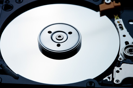 Close up shot of hard disk drive interior showing the metalic shine of the disk