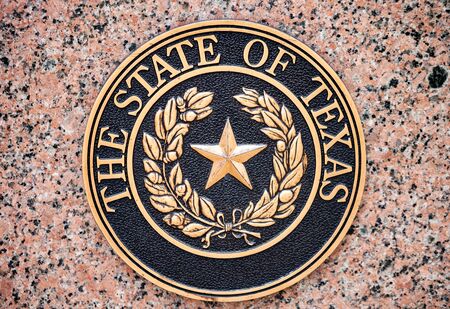 AUSTIN, TEXAS - JULY 2, 2019 - The official seal of The State of Texas mounted on granite wall