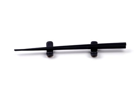 Black chopsticks on a white background.の写真素材