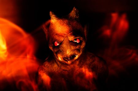A gargoyle is surrounded by flames in an artistic render of the depths of hell.の写真素材