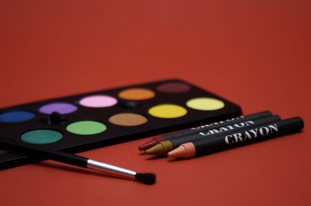 Paint, paintbrush, and crayons. Back to school supplies or an art project.の写真素材