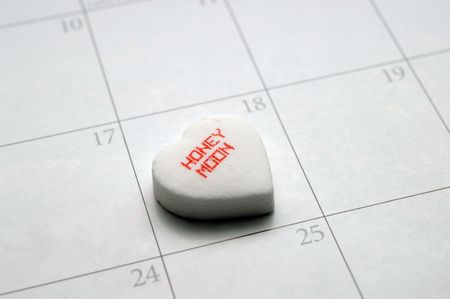 A heart with the words 'honeymoon' placed on a date on a calendar.の写真素材