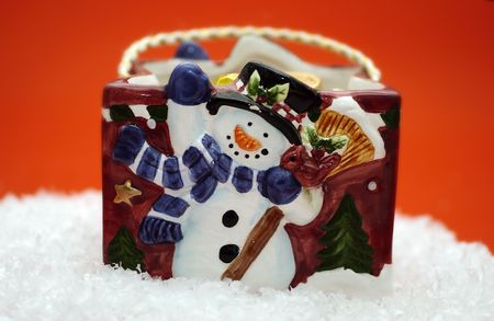 A porcelain bag with a snowman on fake snowの写真素材