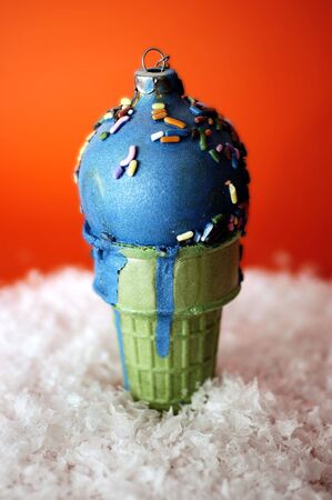 A christmas ornament crafted by a young child on fake snow.