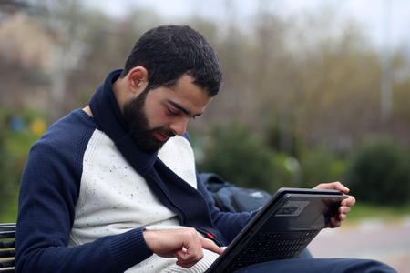 Young man using tablet in parkの写真素材