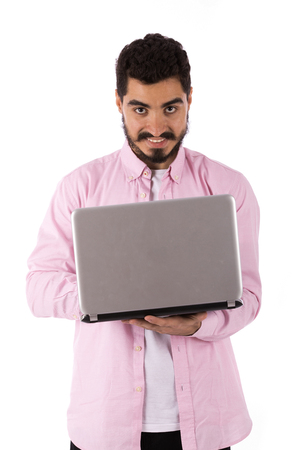 Handsome happy beard young man smiling and using a laptop, guy wearing pink shirt, isolated on white backgroundの写真素材