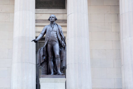 A statue of George Washington stands at the front of the Federal Hall National Memorial on Wall...