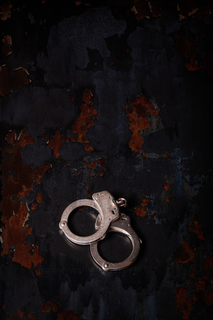 Handcuffs on a black background.の写真素材