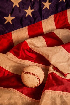 A baseball with an American Flag background and a vintage lookの写真素材